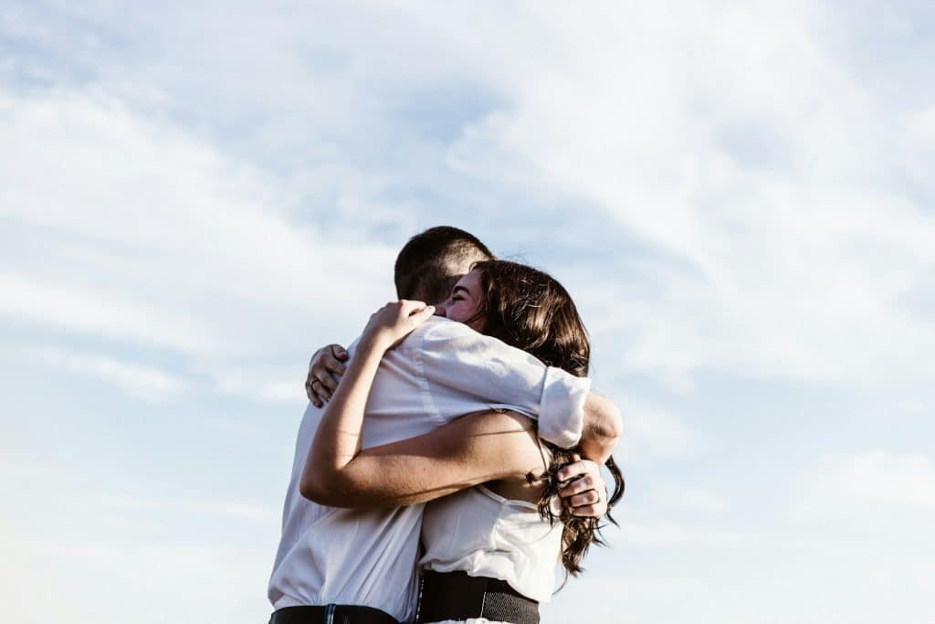 The couple is hugging each other.