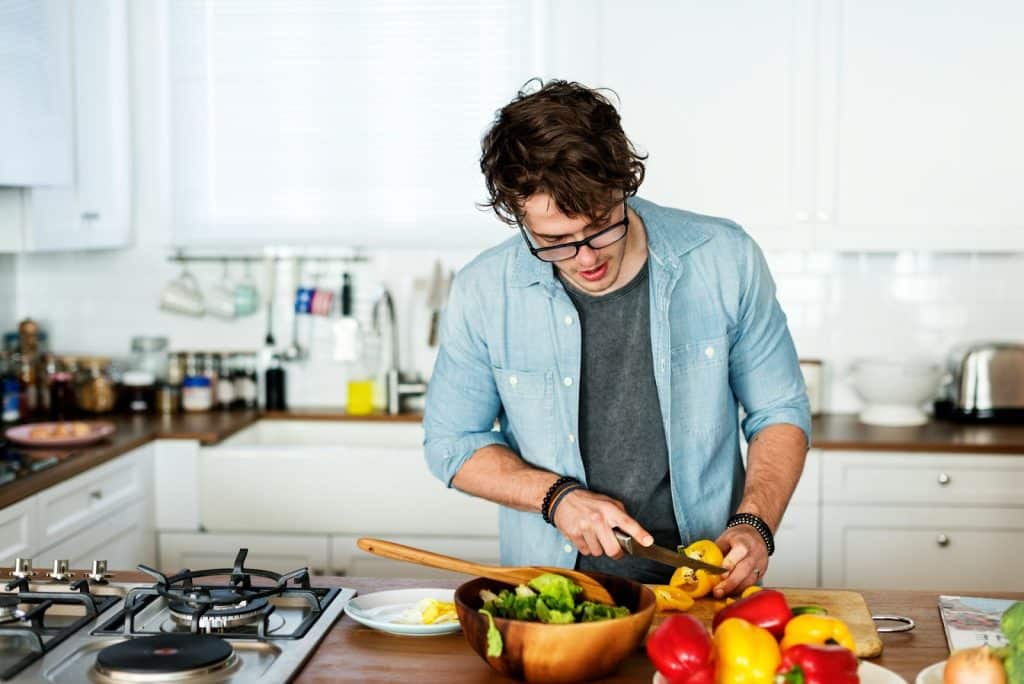 The man is cooking in the kitchen.