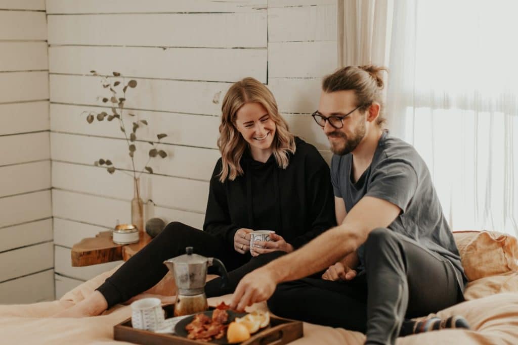 The couple is having breakfast in bed.
