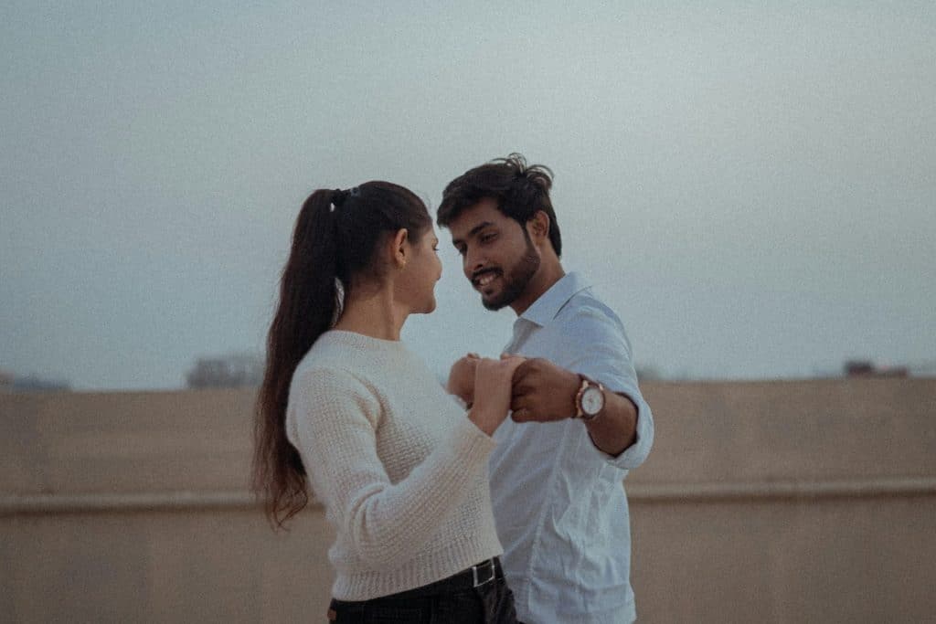 The man and the woman are standing next to each other.