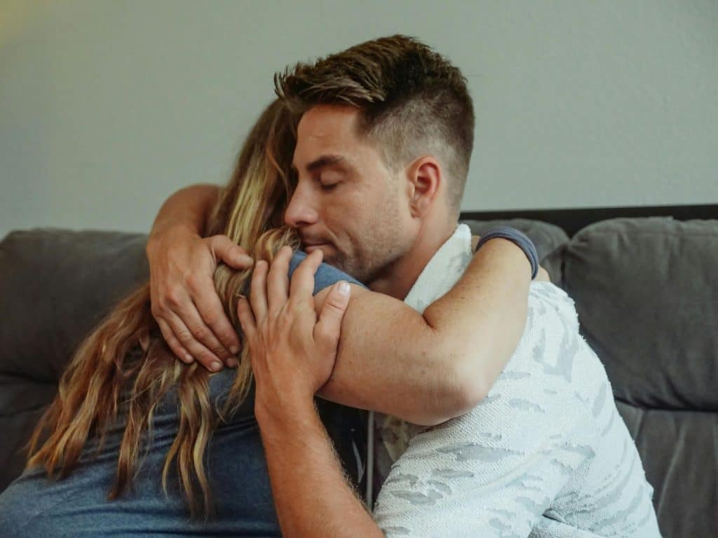 A man and woman hugging each other