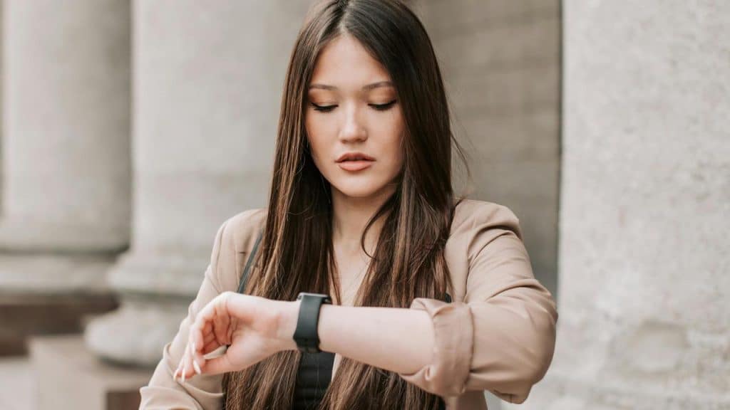 A woman looking at her smartwatch.