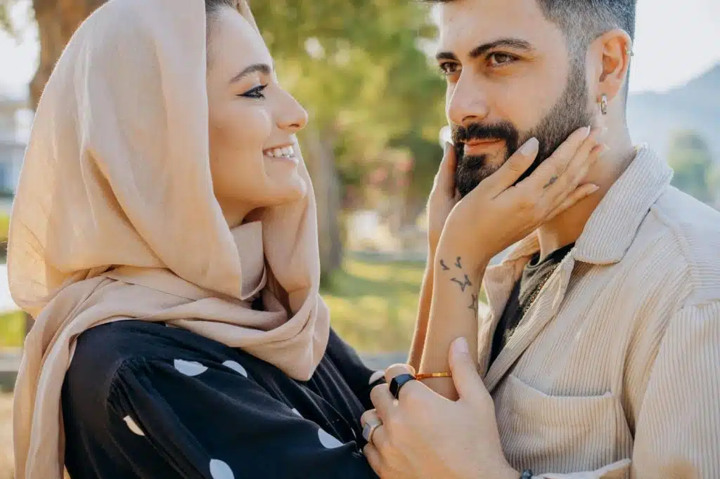A woman holding a man’s face