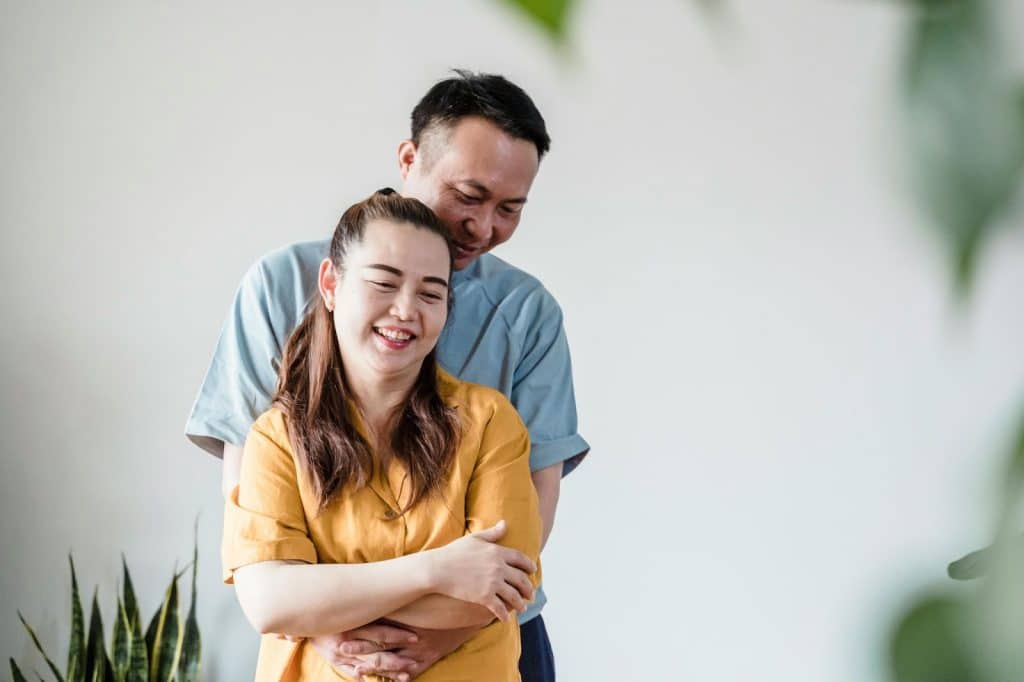A man hugging a woman from behind