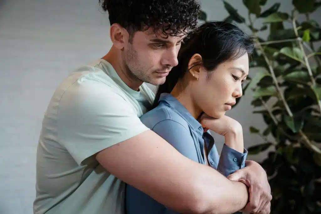 A man hugging a woman from behind