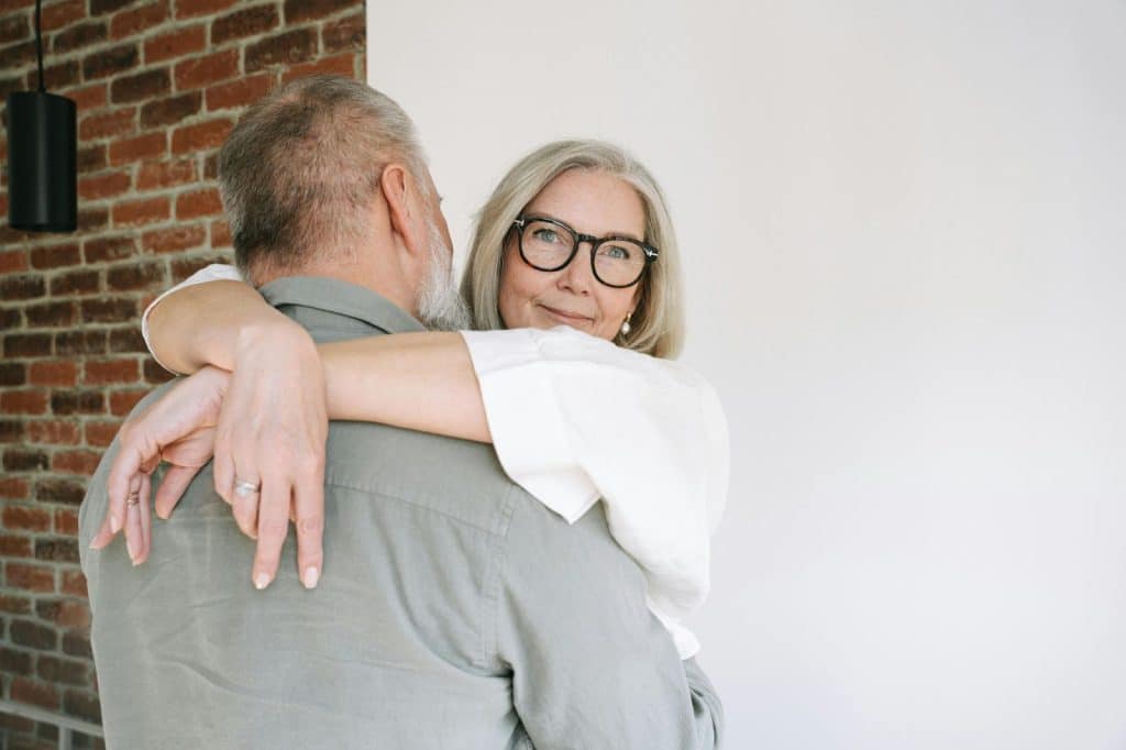 A man and woman hugging each other