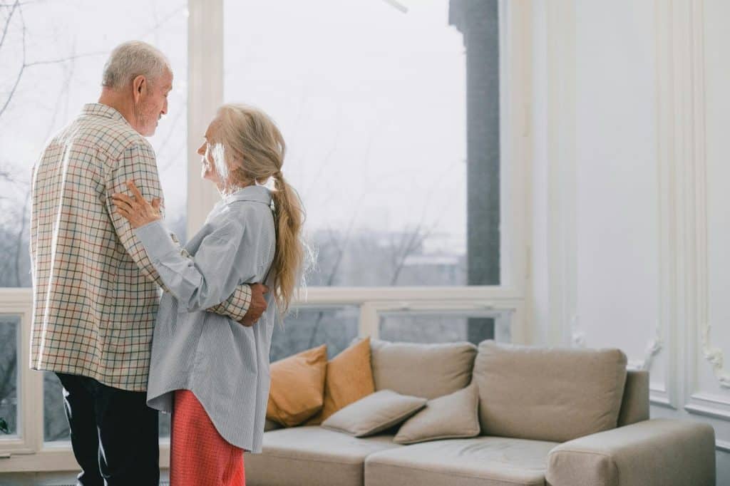 A man and woman dancing at the living room