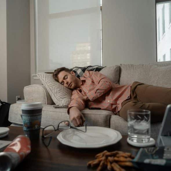 A man sleeping soundly on a couch.