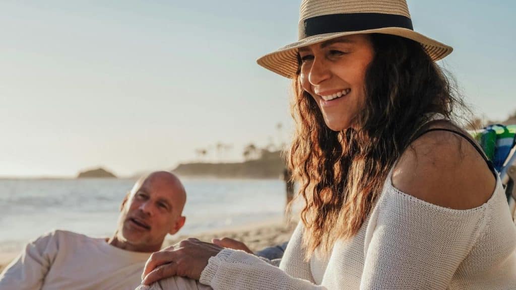 A couple relaxing together on the beach.