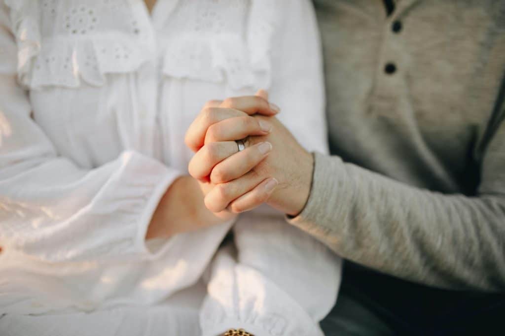 A man and woman holding hands