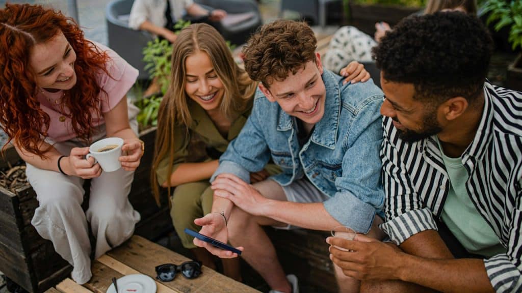A smiling group of friends engaged in a discussion.