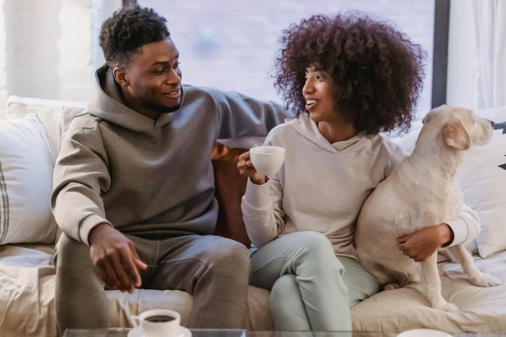 A man and woman sitting at the couch