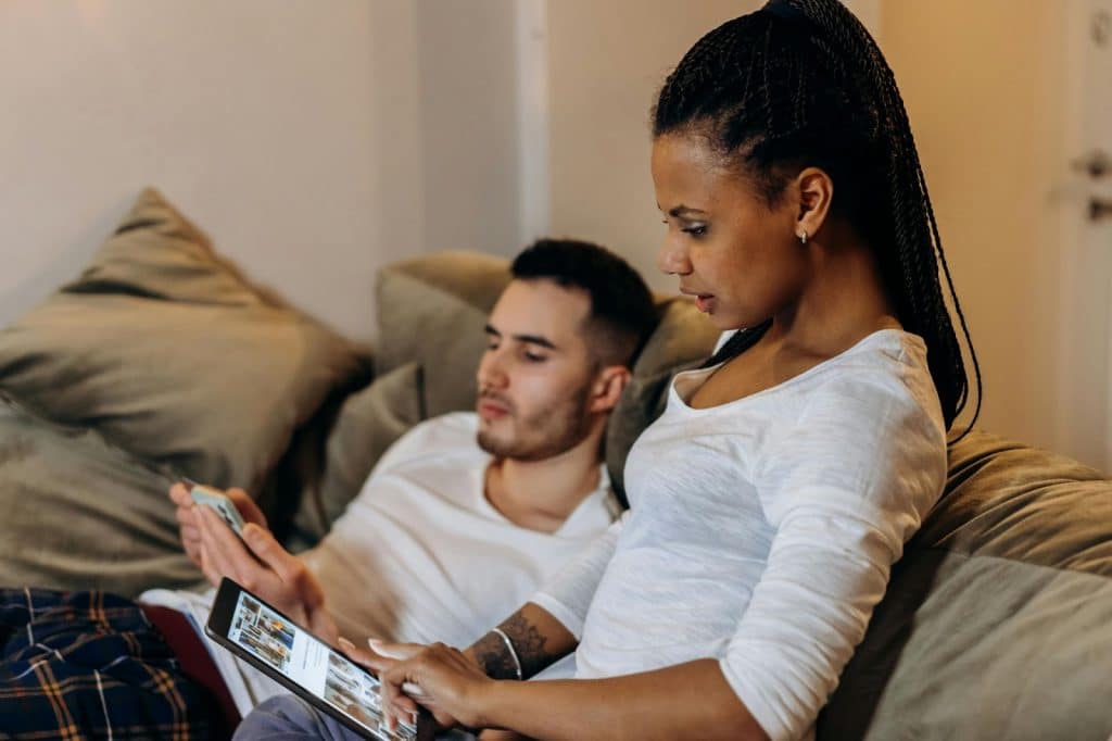 A man and woman having their own screen time together