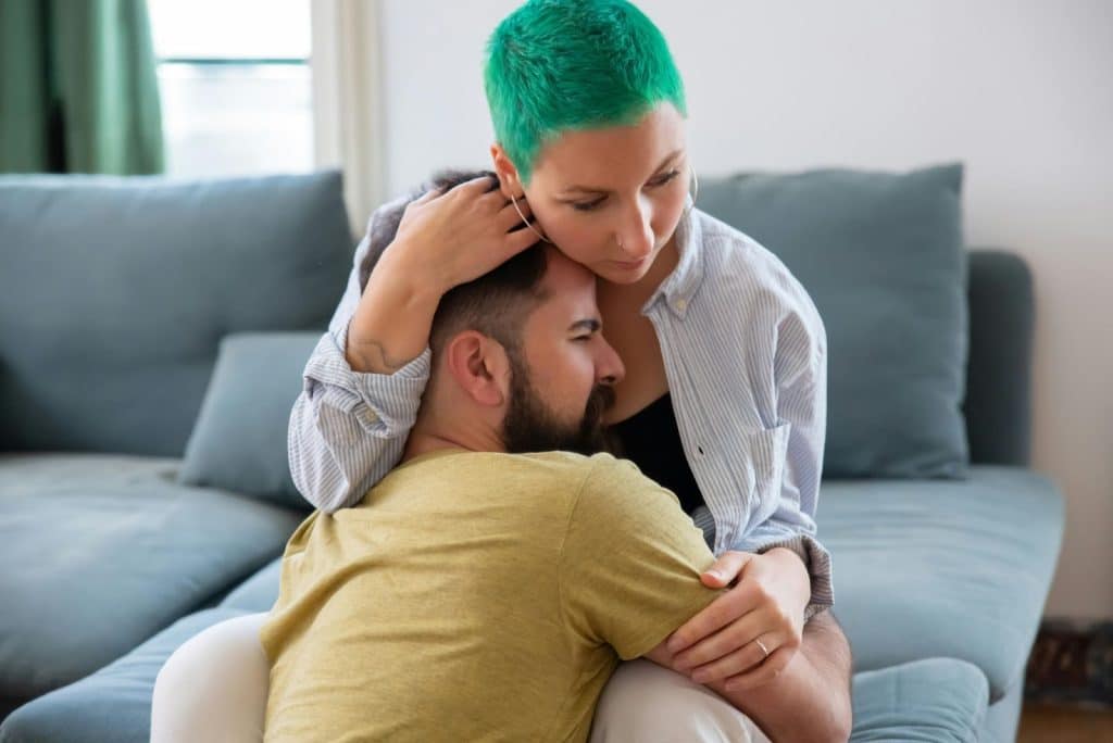A man hugging a woman