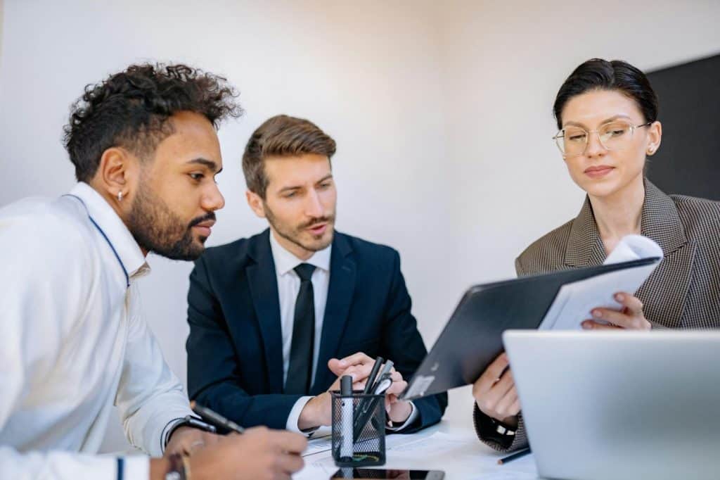 Two men and woman working together