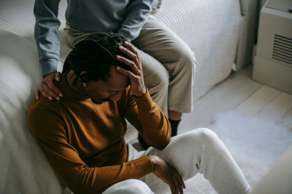 A woman comforting a frustrated man