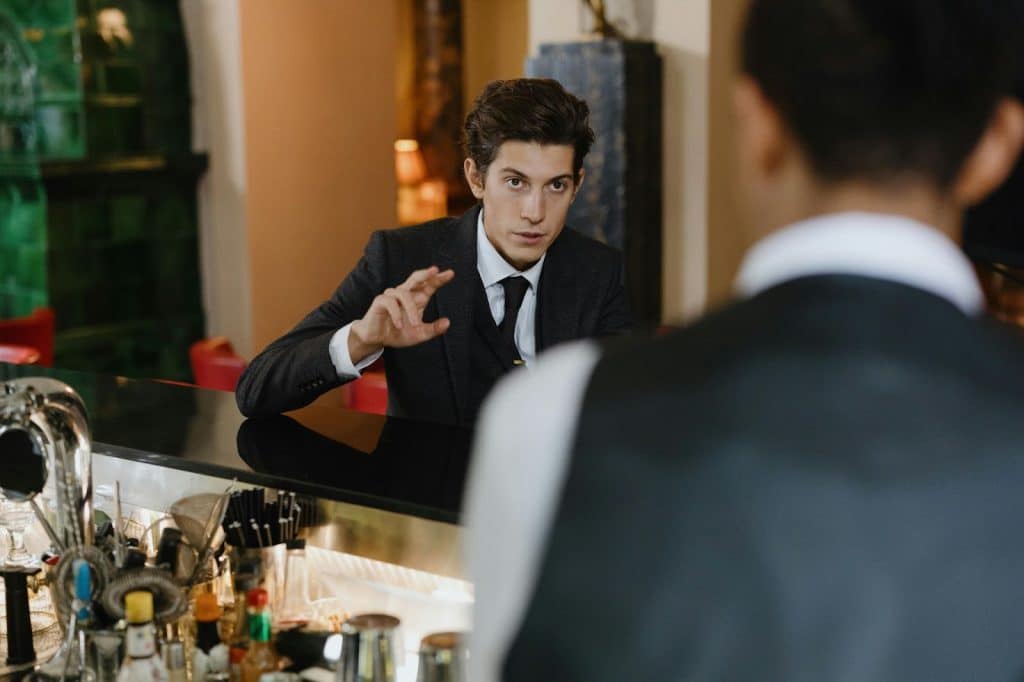 A man talking to a waiter