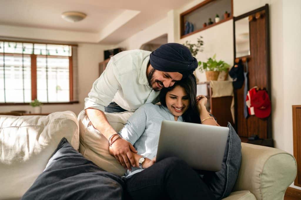 A man and woman checking bank accounts