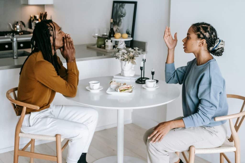 A man calming himself and a woman talking