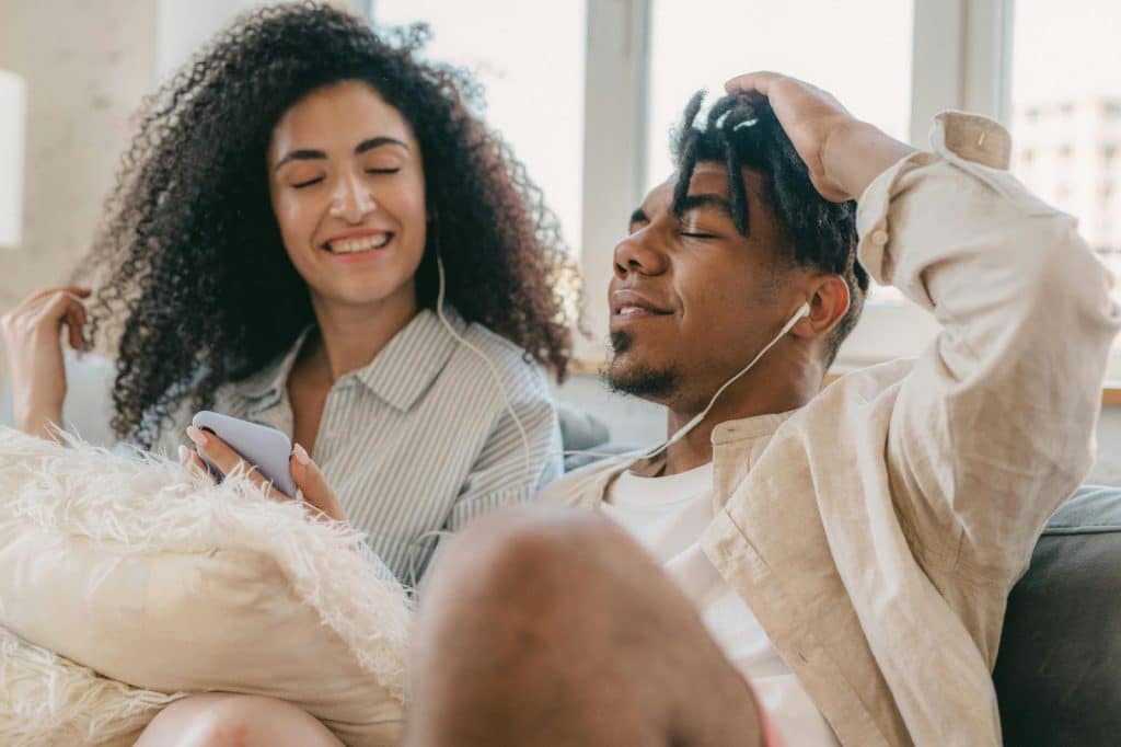 A man and woman listening to a song