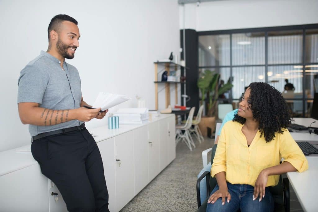 A man asking questions politely to a woman