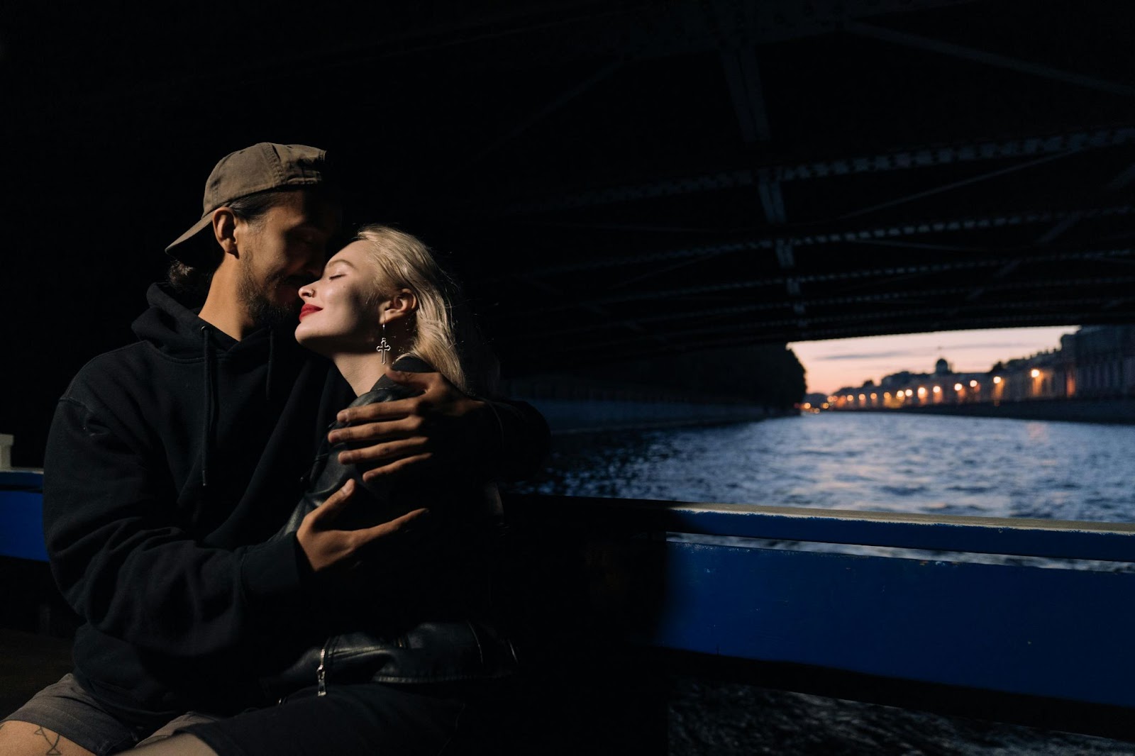 A man kissing a woman’s forehead