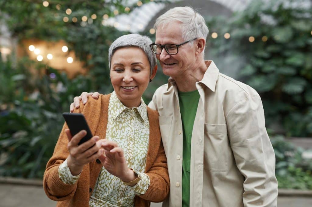A man and woman using phone