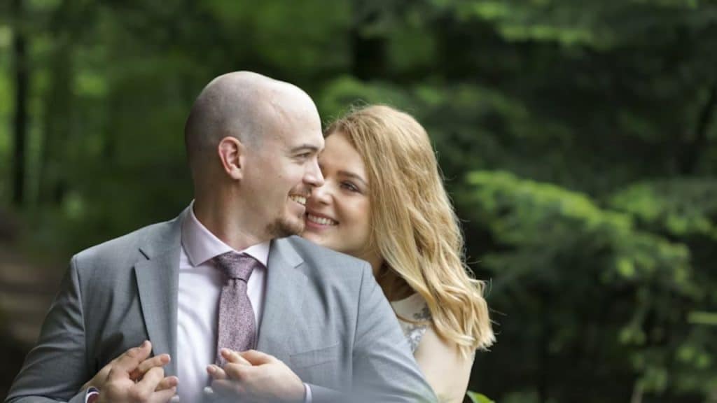 Woman complementing his husband for his style and hugging him from behind