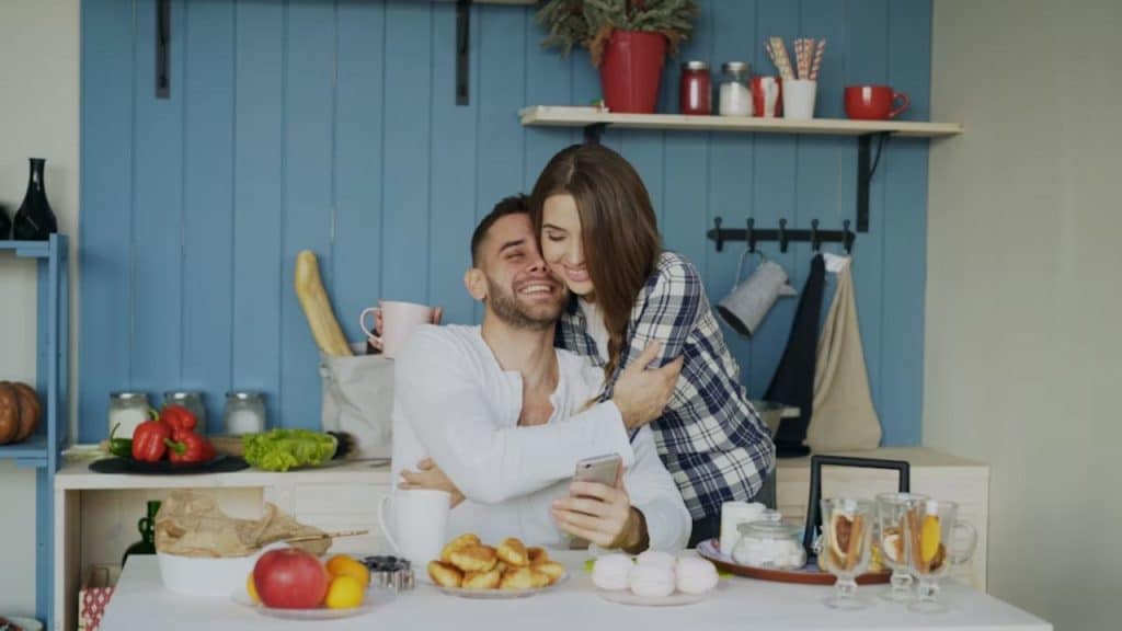 Couple hugging warmly in their kitchen