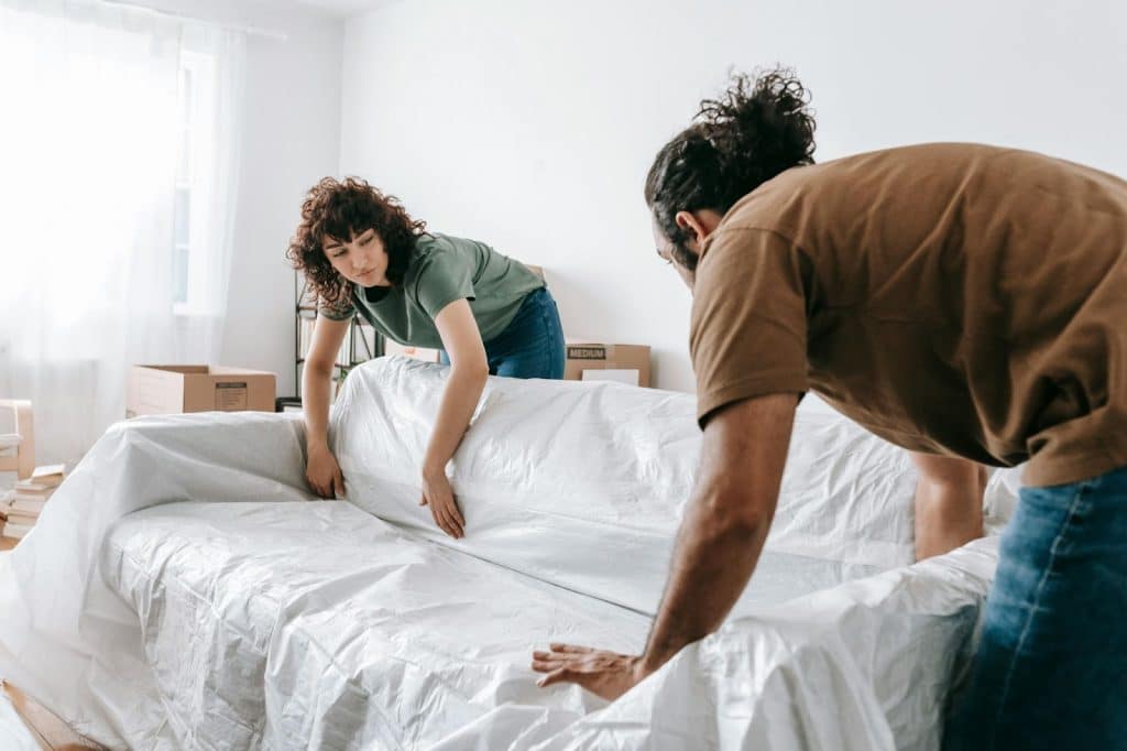 A man and woman fixing sheets