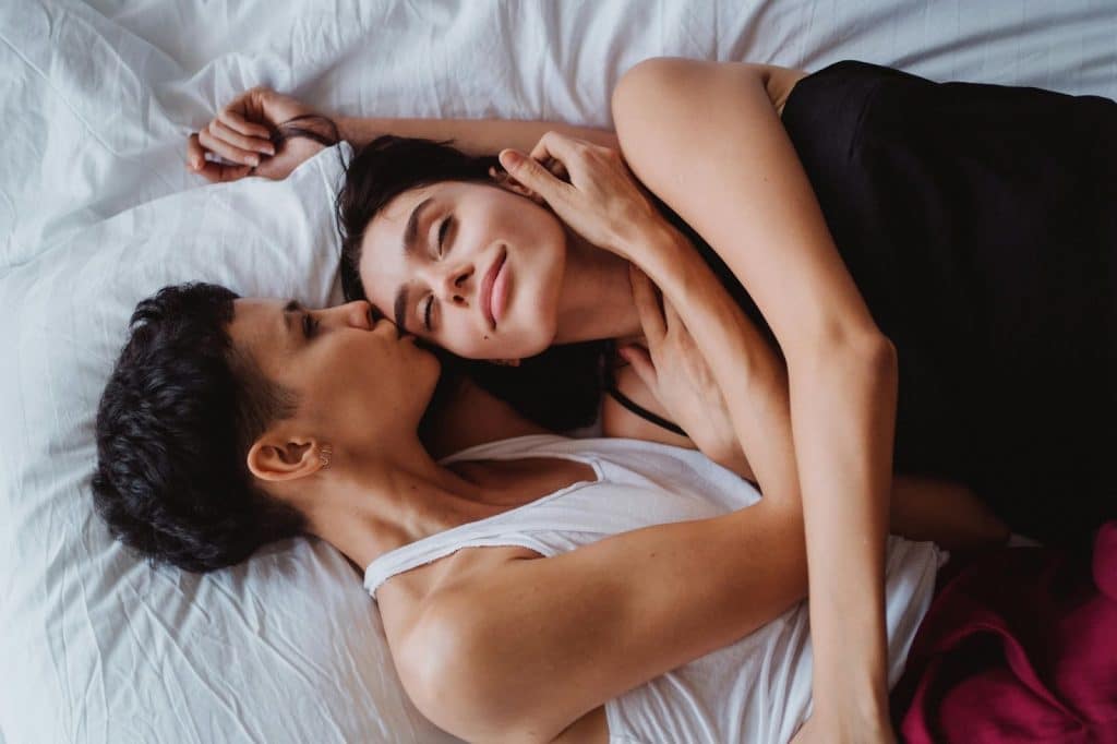 A man and woman at the bed