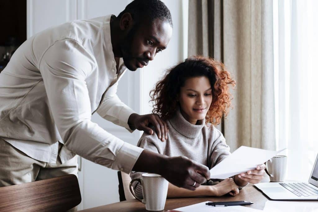 A man and woman helping each other