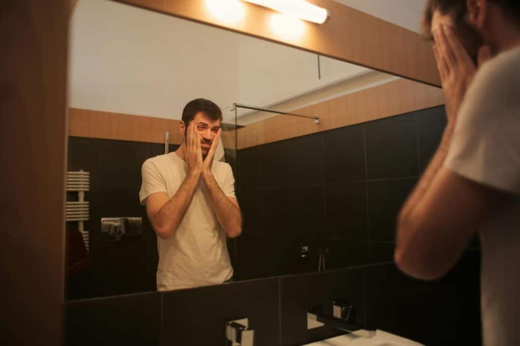 A man looking at the mirror