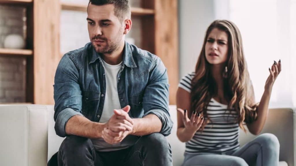 Couple in conversation, man interrupting while the woman looks annoyed