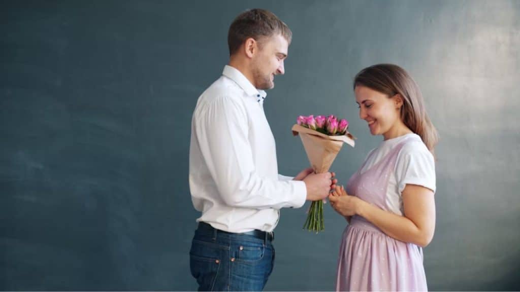 Man giving flowers to his wife