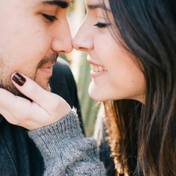 A woman holding a face of a man