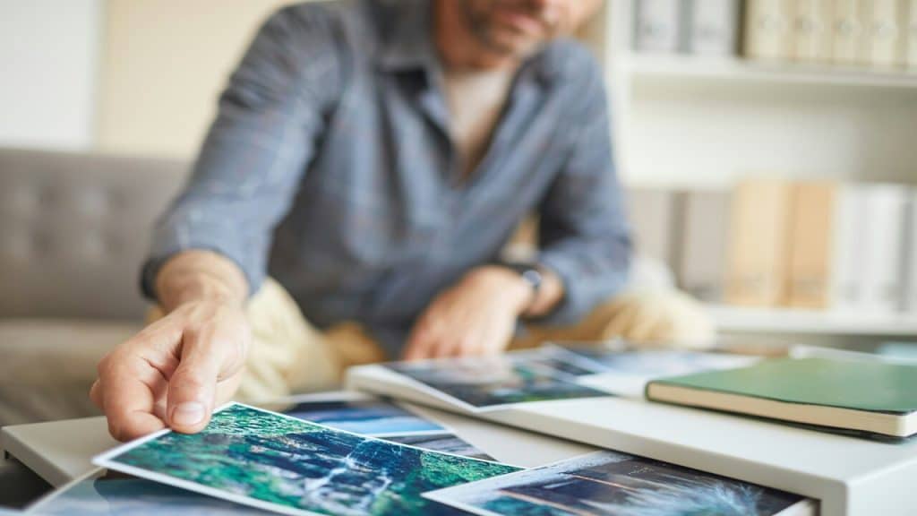 A man looking at old photos