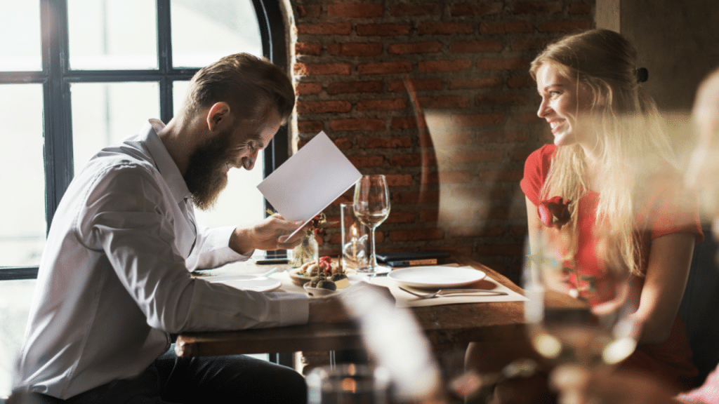 A woman watching her husband while they order food