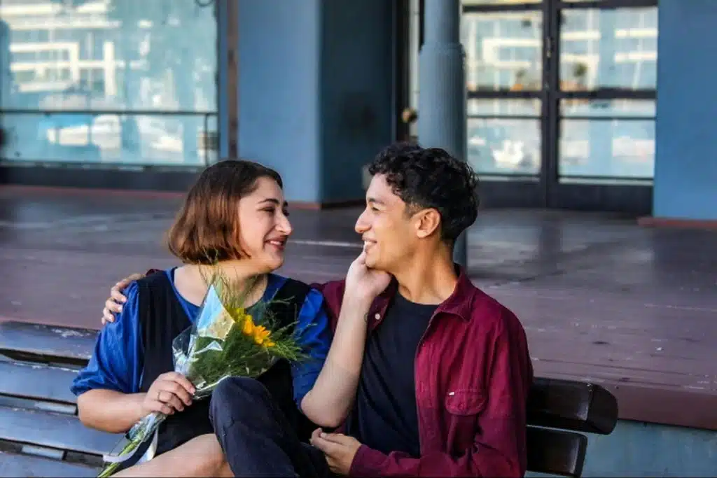 A man giving a woman a flower