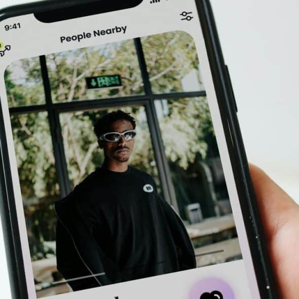 A person’s profile on a dating app shown on a smartphone.