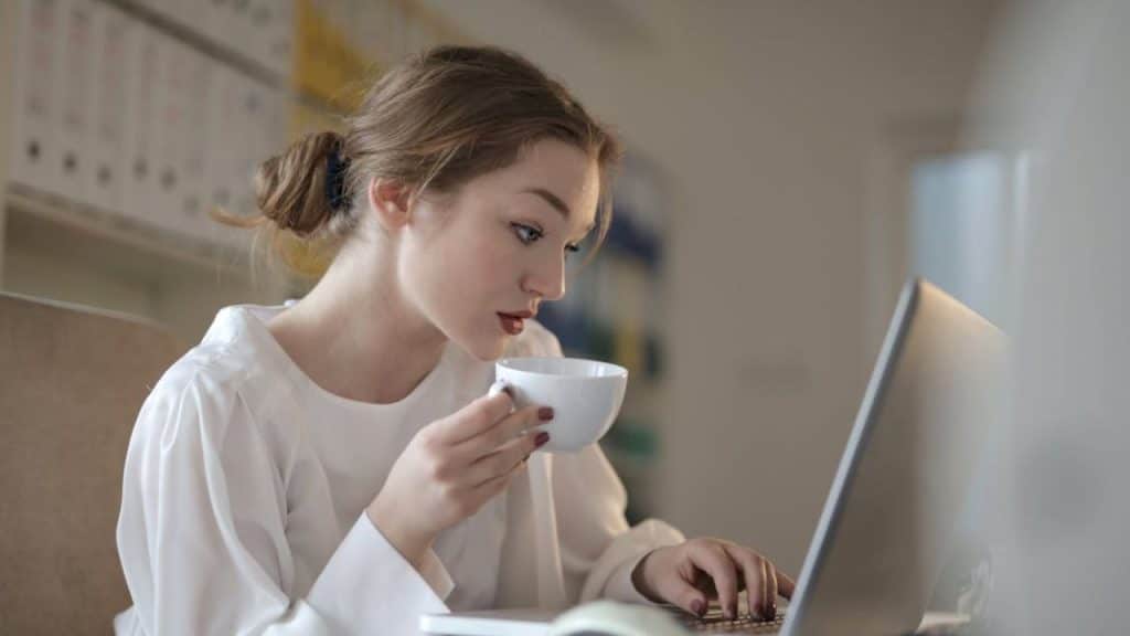 A wife journaling while drinking tea