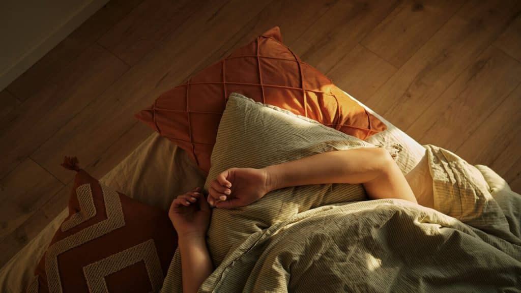 A person hiding under the blanket