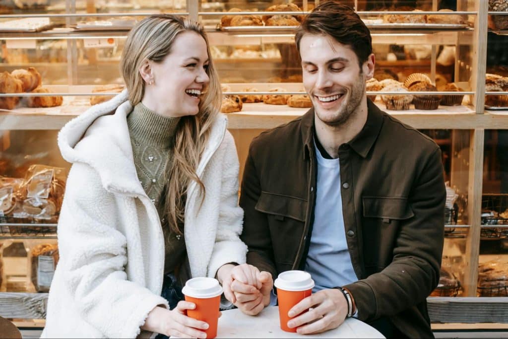 A man making a woman laugh