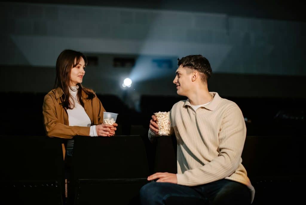 The couple is in a movie theater.