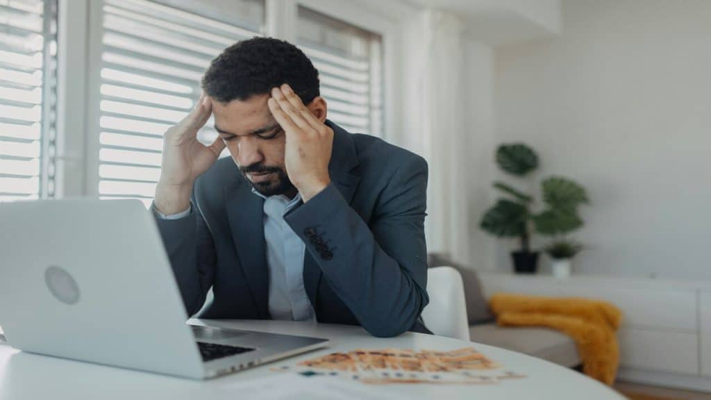 A man looking stressed while working from home