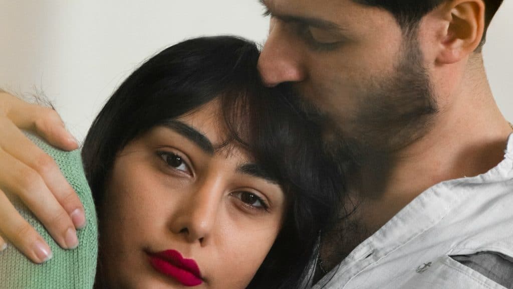 A man and a woman embracing each other.