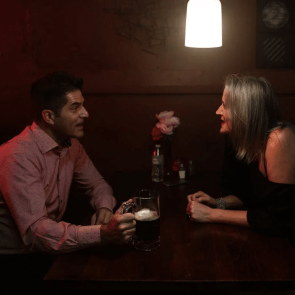 A Man and Woman Sitting at the Table Talking