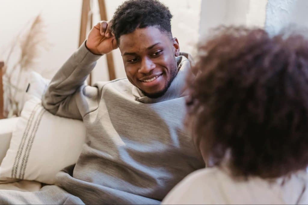 A man smiling at the woman
