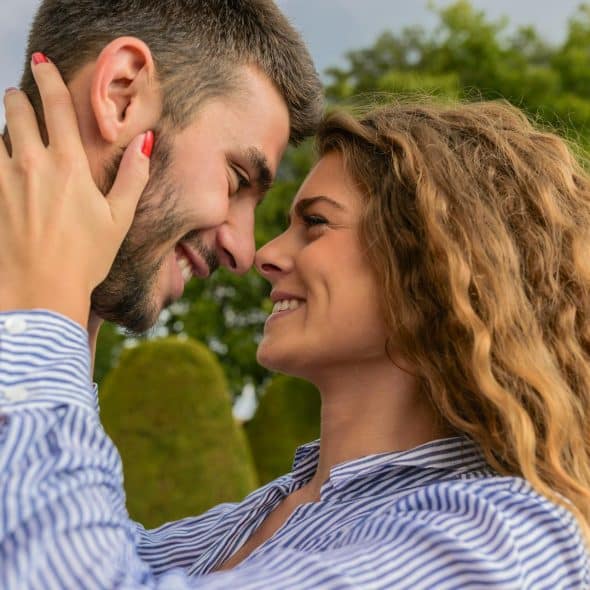 The couple lovingly looks at each other.