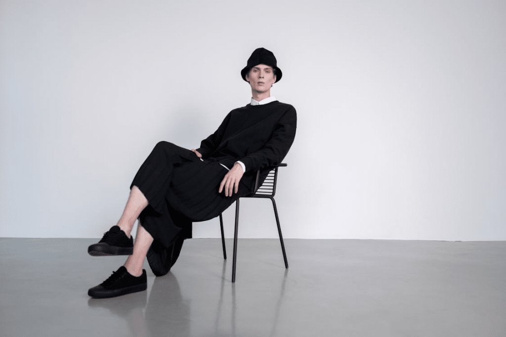 Man in Black Long Sleeves Sitting on the Chair